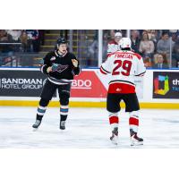 Kelowna Rockets left wing Dawson Gerwing (left) prepares to mix it up