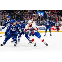 Syracuse Crunch defenseman Tommy Miller (left) looks to lay a hit vs. the Laval Rocket
