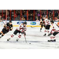 Rapid City Rush's Blake Bennett, Bobby Russell, and Brett Davis and Indy Fuel's Lee Lapid on the ice