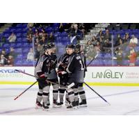 Vancouver Giants' Tobias Tomik and Kaleb Hartmann talk with teammates